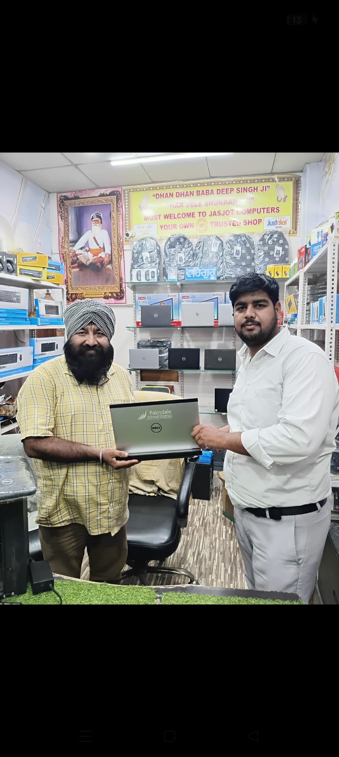 A customer visit pictured inside Jasjot Computers